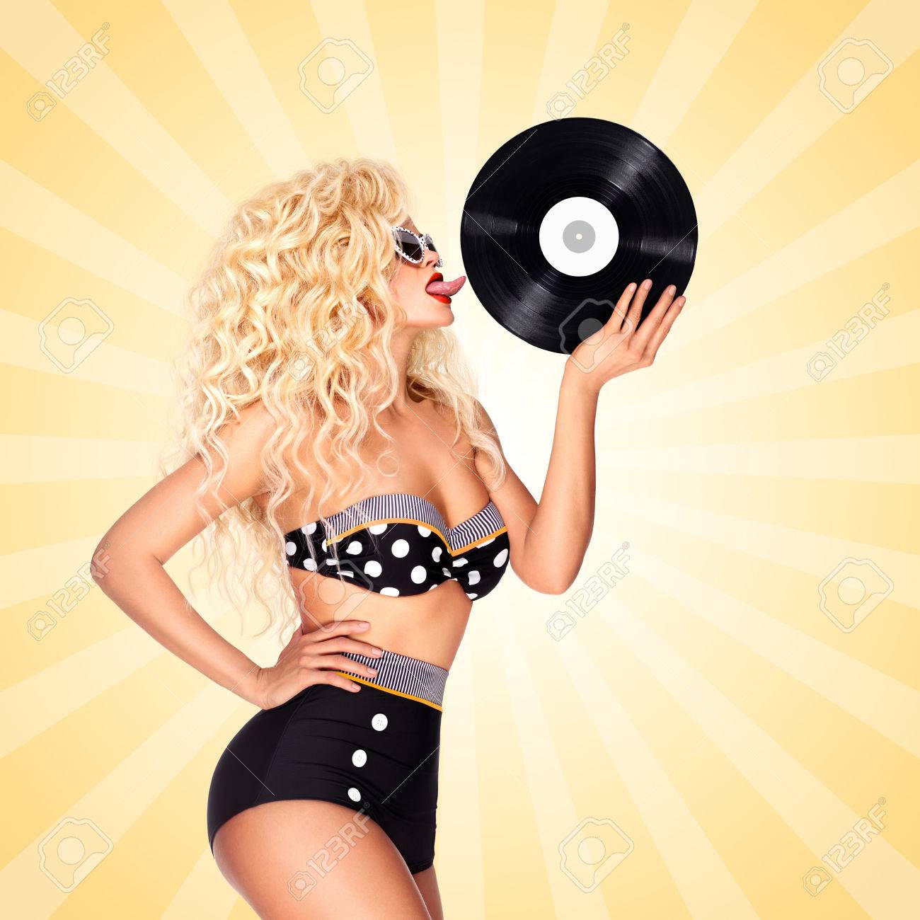 77012649-beautiful-pinup-bikini-model-licking-lp-microgroove-vinyl-record-on-colorful-abstract...jpg